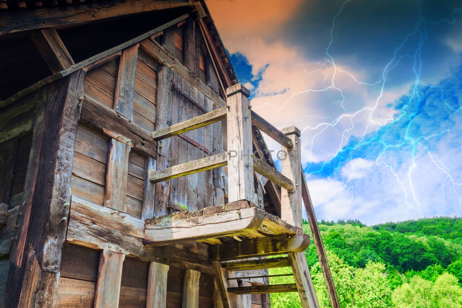 Idyllic Alpine shelter or chalet in summer on a mountain meadow during thunderstorm.