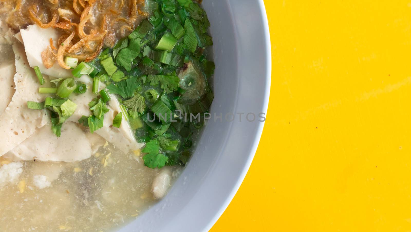Closeup rice soup on yellow table  by pt.pongsak@gmail.com