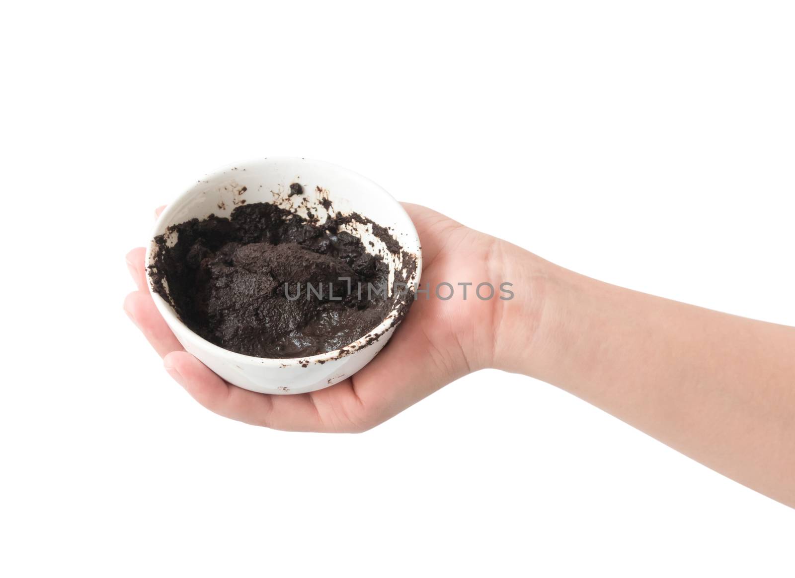 Woman's hand holding bowl of coffee grounds for skin scrub, health care and beauty concept