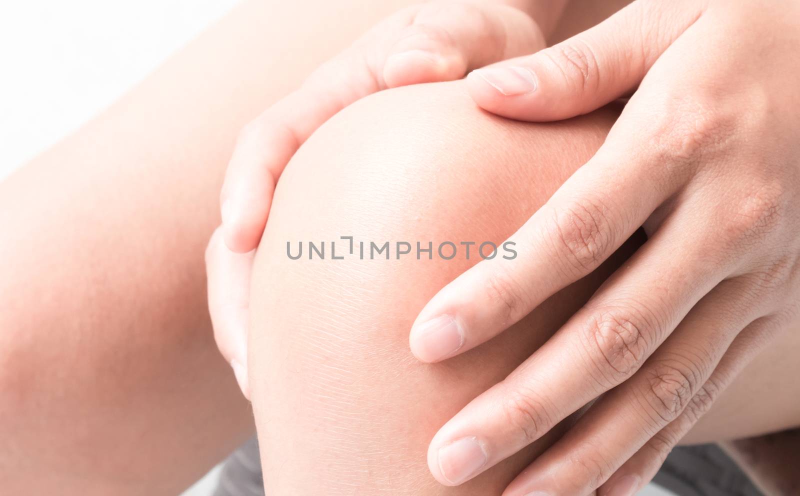 Closeup woman hand hold knee with pain symptom, health care and  by pt.pongsak@gmail.com