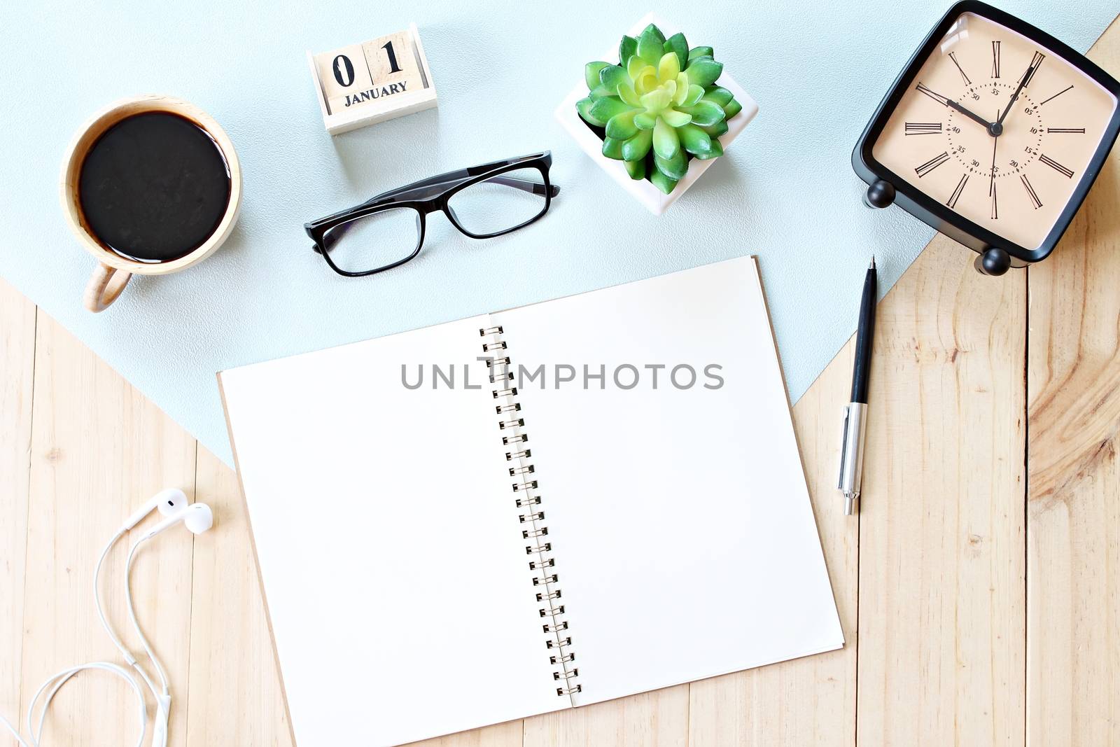 Business, weekend, holiday or new year planning concept : Top view or flat lay of open notebook paper, accessories, cube calendar and coffee cup on wooden background, ready for adding or mock up