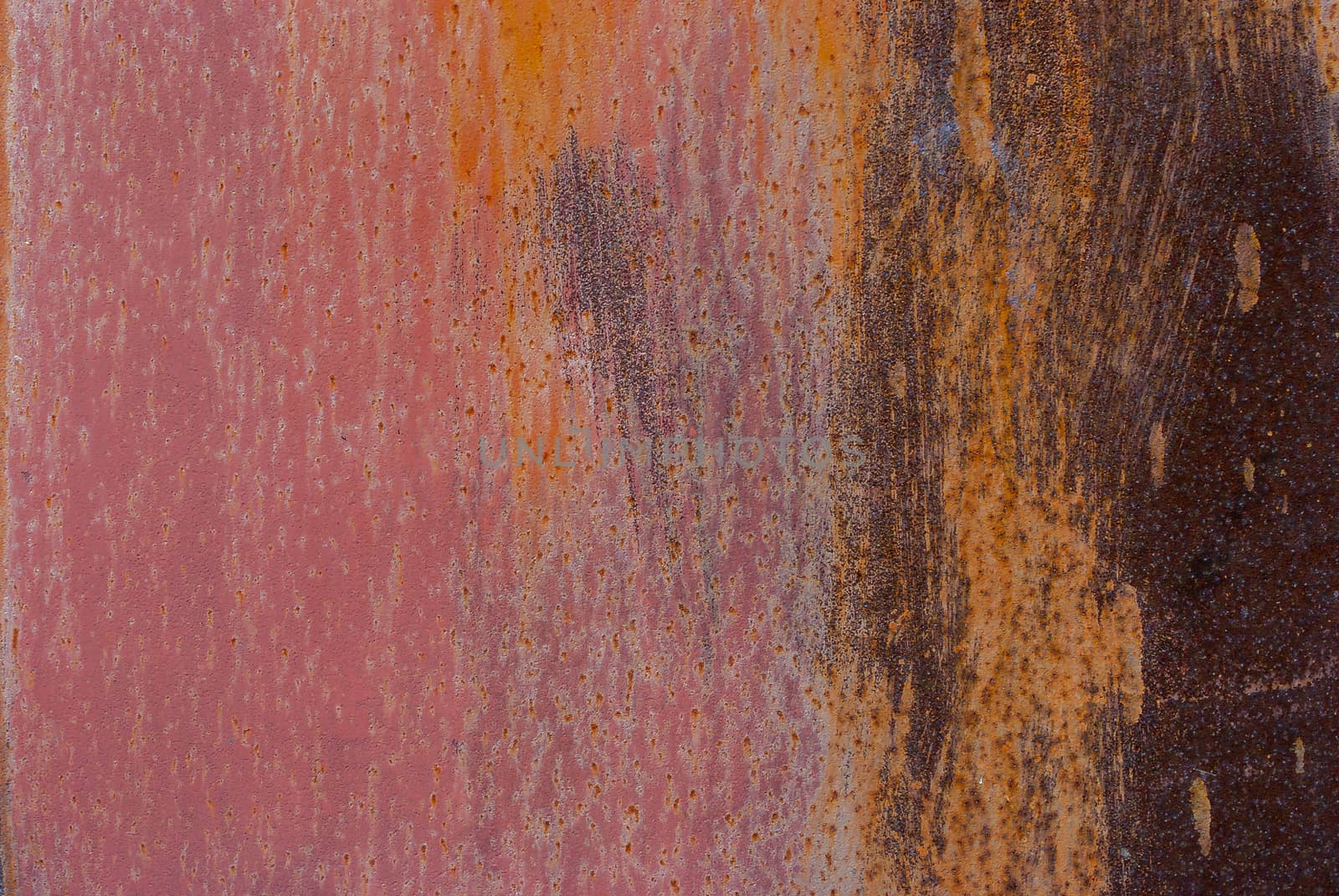 rusty iron surface covered with old chipped paint, which has long been influenced by different climatic conditions