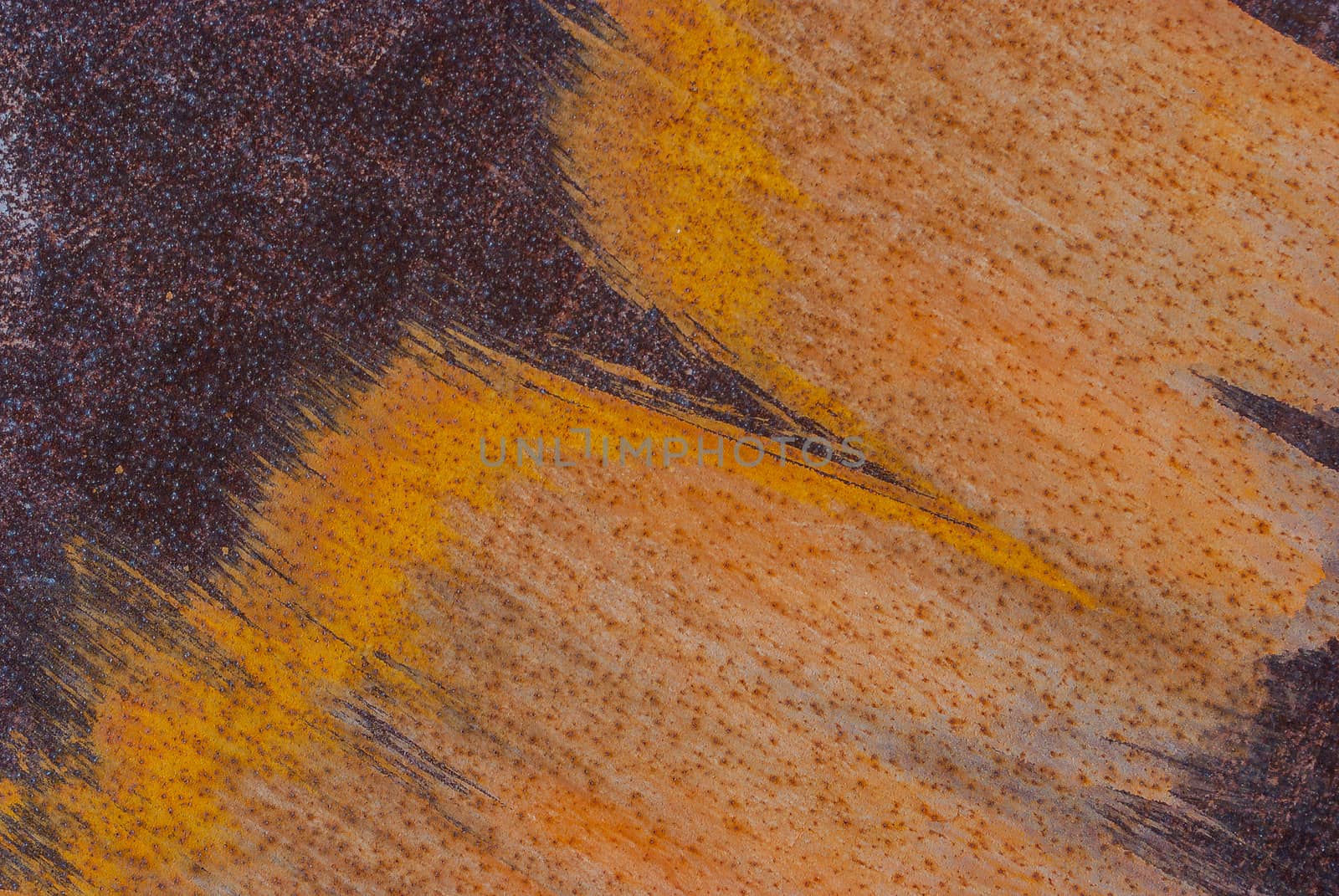 rusty iron surface covered with old chipped paint, which has long been influenced by different climatic conditions