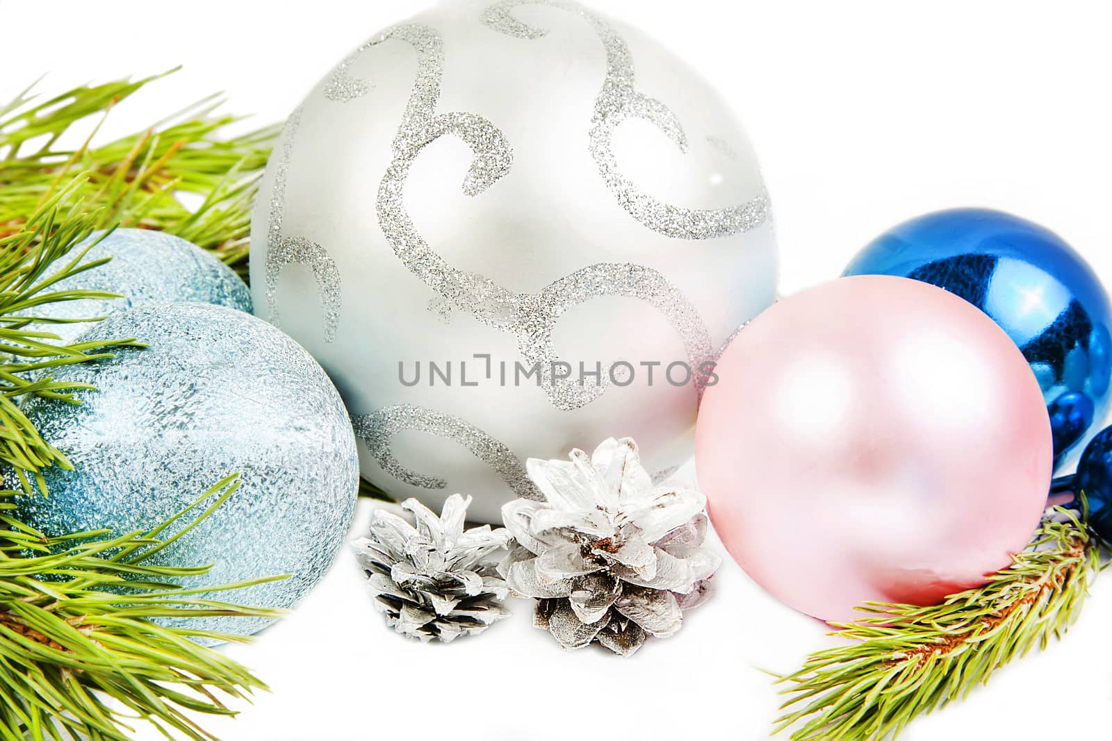 New year composition with fir tree branch, beautiful silver ball and silver cones close up