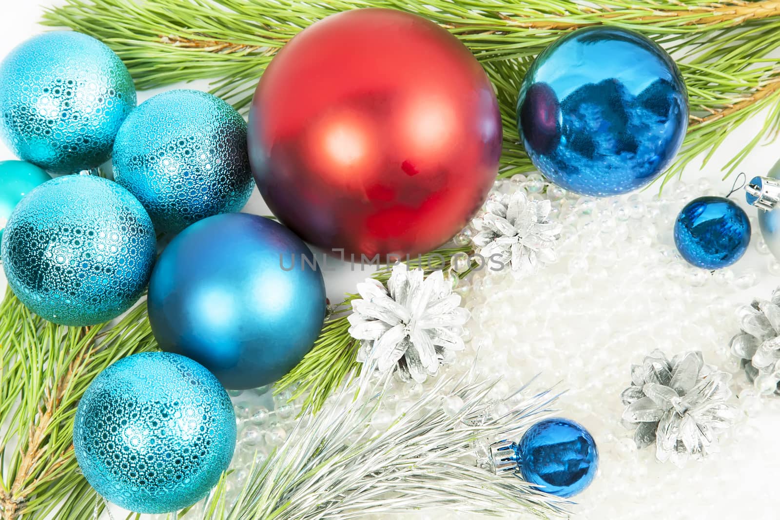 New year decorations on white background with balls and fir tree branch