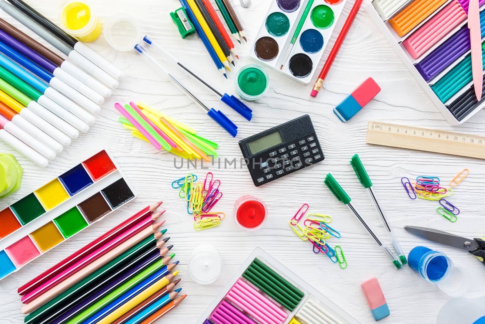 School supplies on a white background, paints and brushes