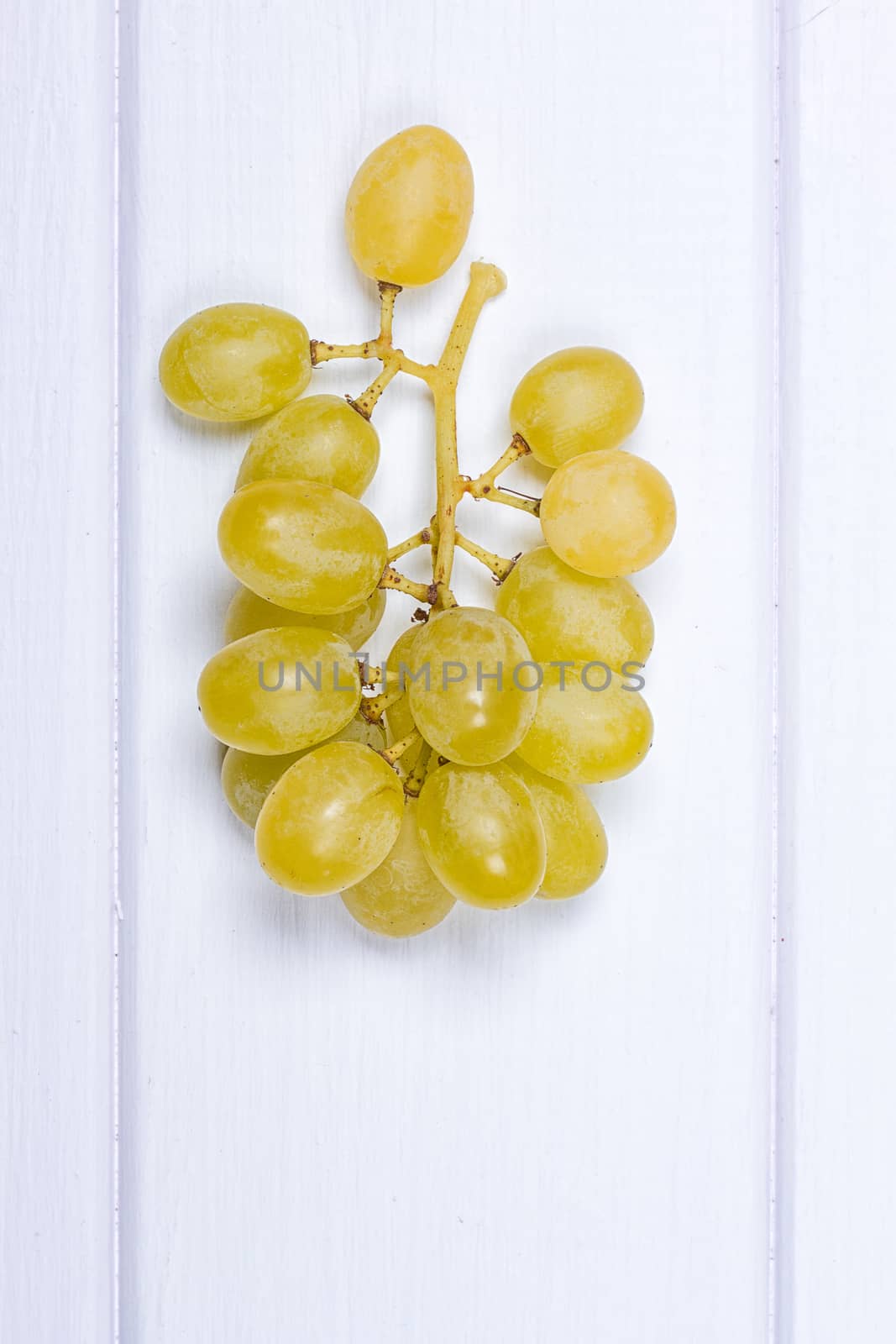 White grapes on white wooden surface. top view. copy-space