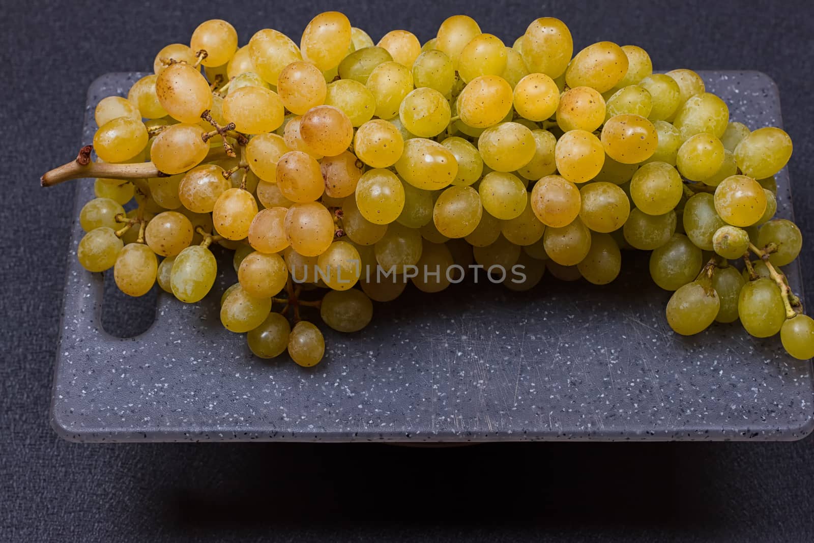 fresh delicious and healthy organic concord grapes on cutting board