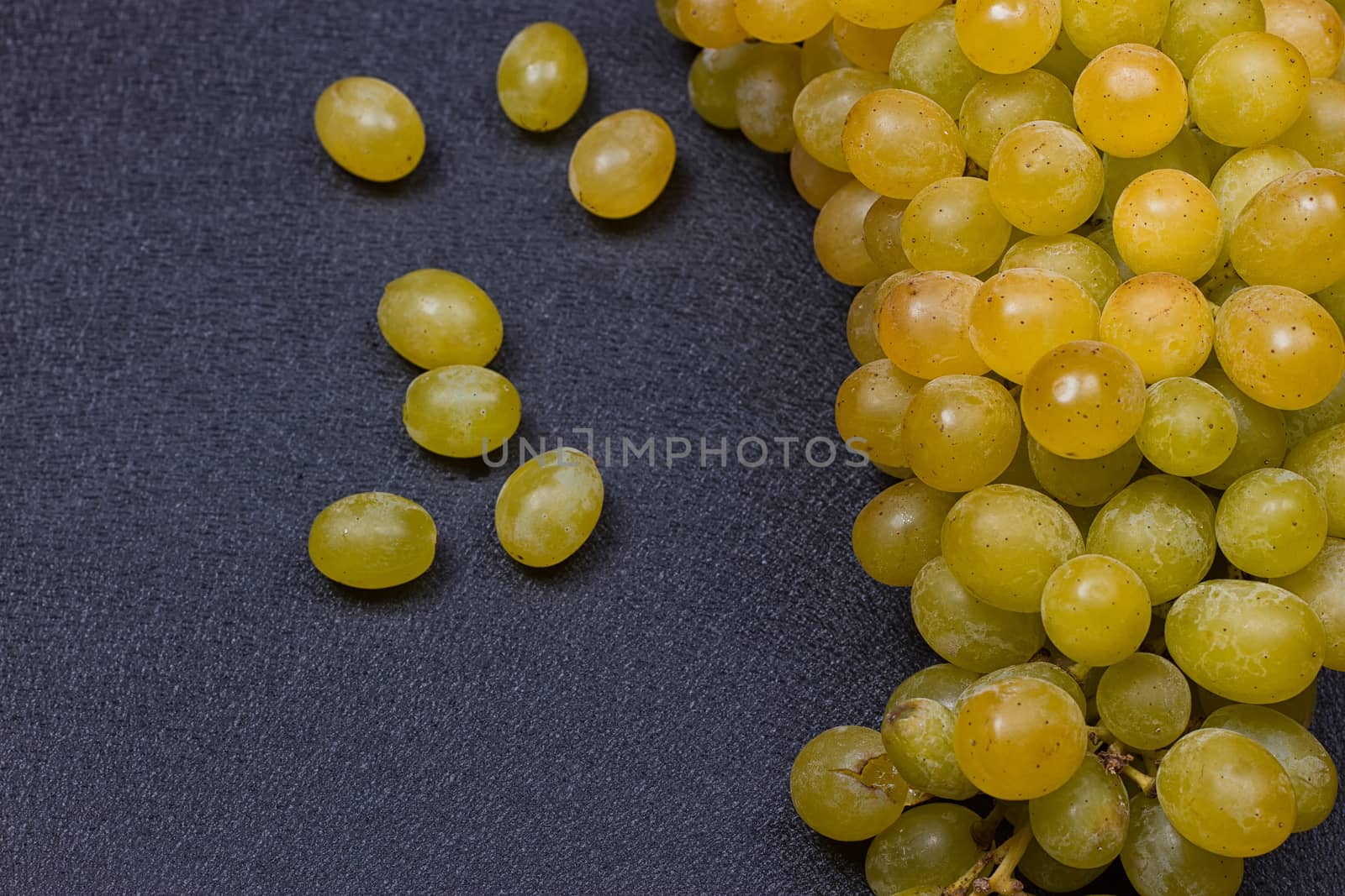 White grapes on a black background. copy-cpace