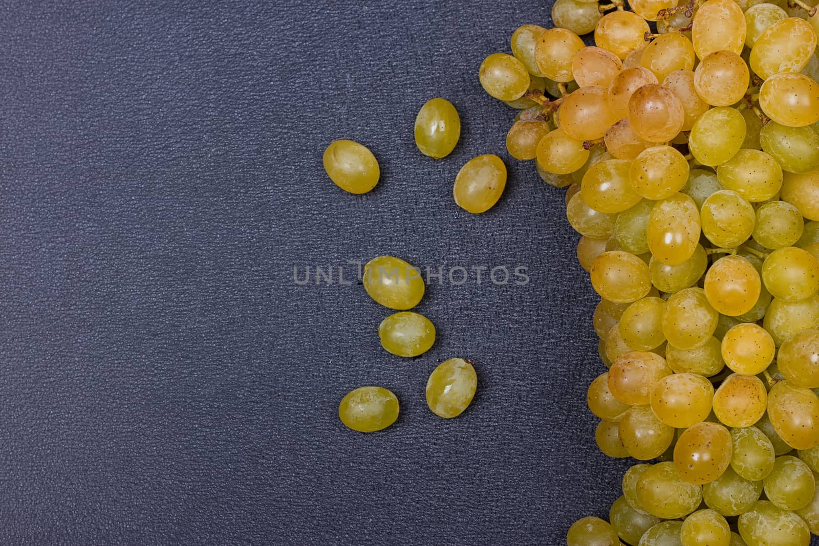 White grapes on a black background. copy-cpace