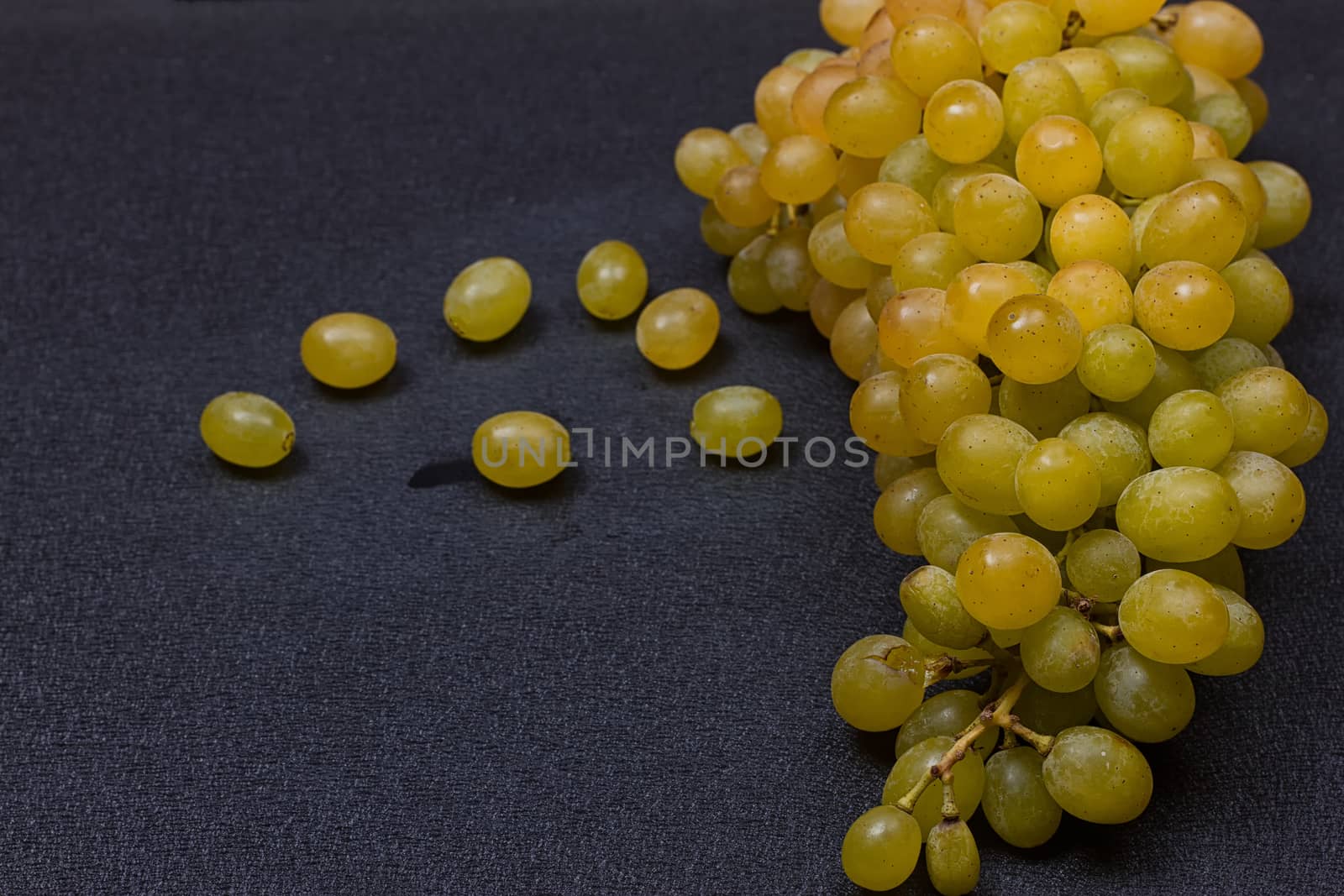 White grapes on a black background. copy-cpace