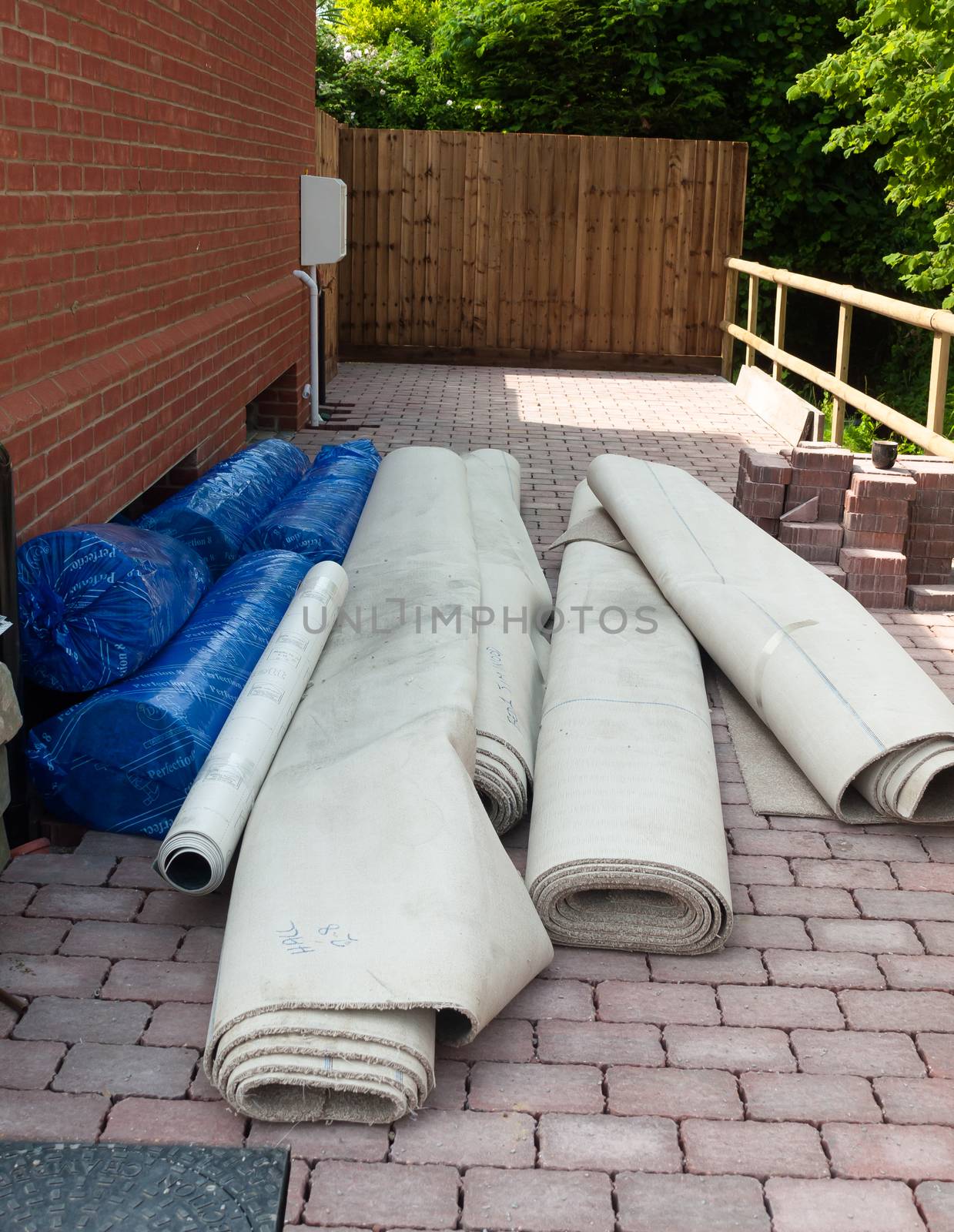 rolled up construction materials outside new house on floor; England; UK