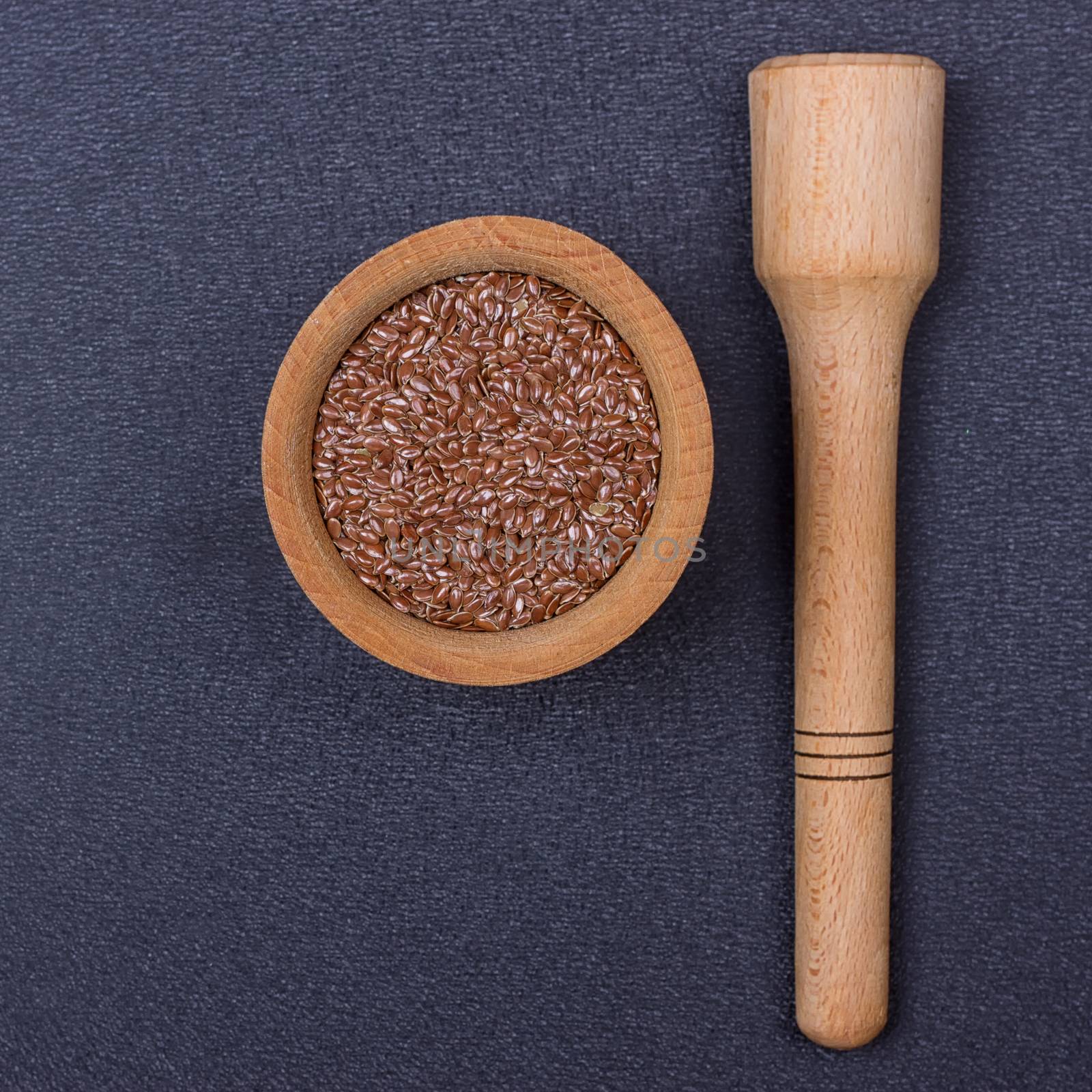 Flax seed in a wooden bowl by victosha