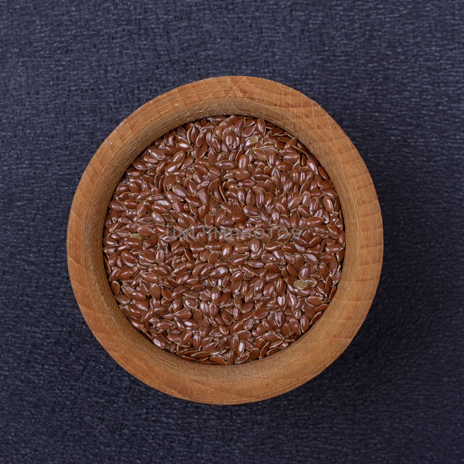 Flax seed in a wooden bowl by victosha