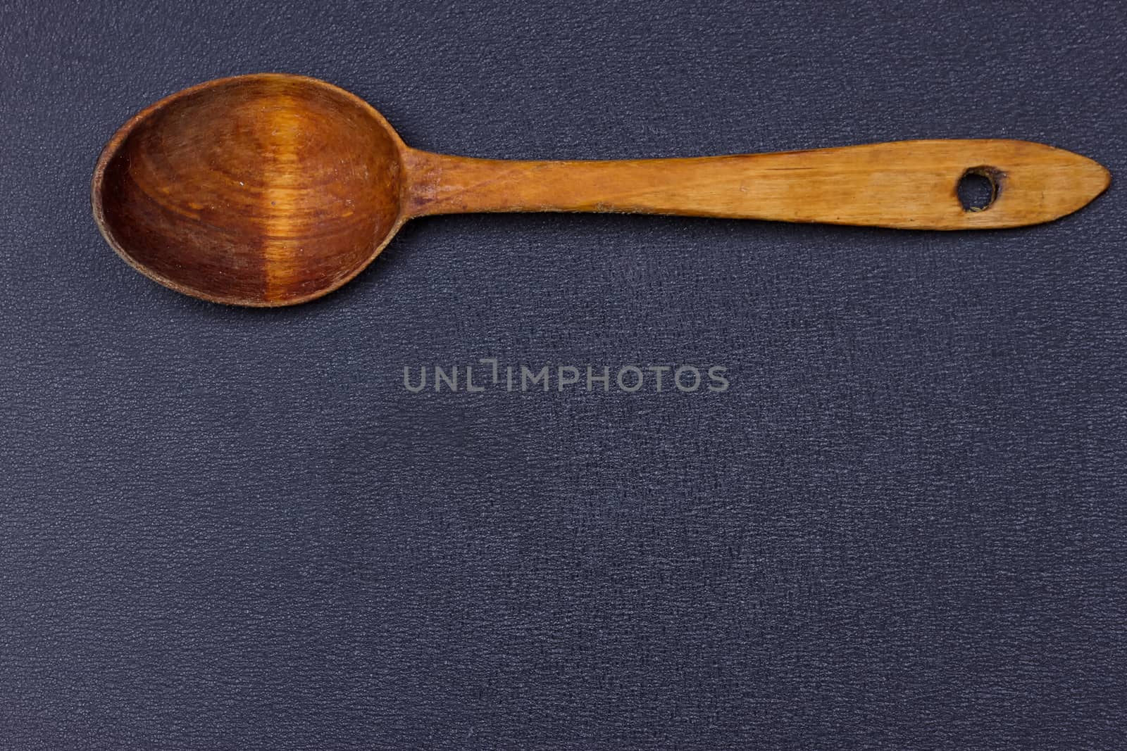 a wooden spoon on the black background