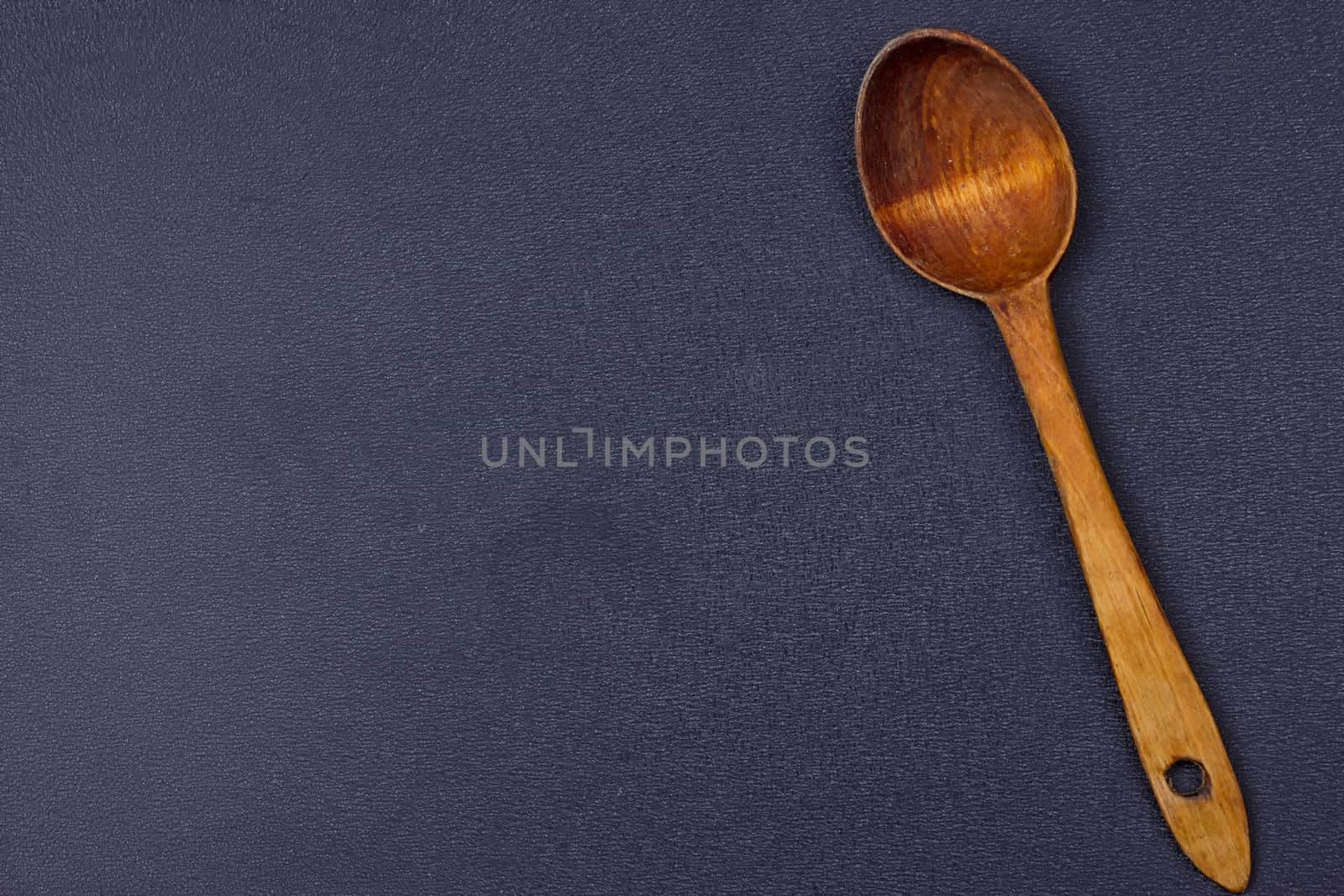 a wooden spoon on the black background