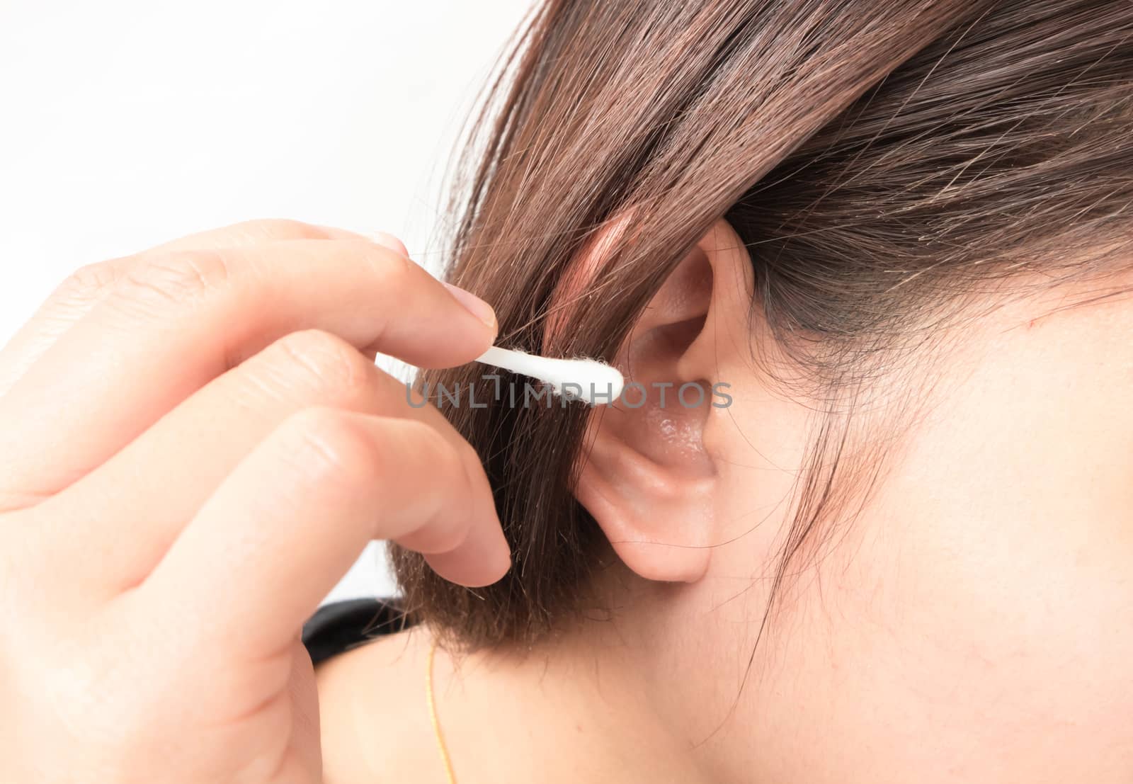 Closeup woman cleaning ear with cotton bud, health care concept by pt.pongsak@gmail.com