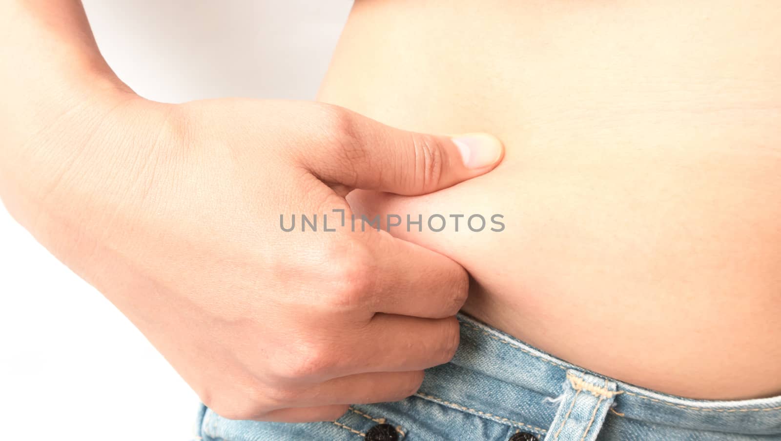 Closeup hand holding abdominal surface woman fat, healthy care and beauty concept