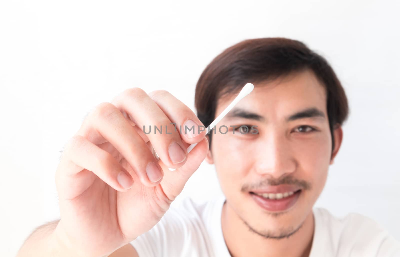 Closeup man hand holding cotton bud for cleaning ear , health care concept