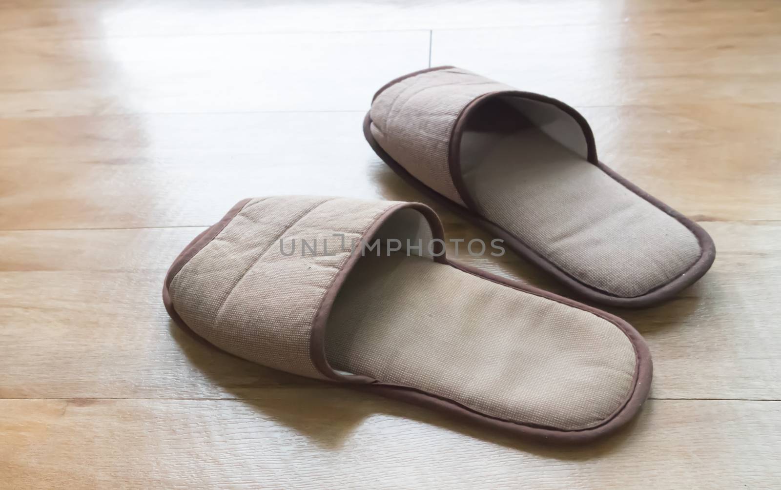 Brown house slippers on wood floor, relax concept by pt.pongsak@gmail.com