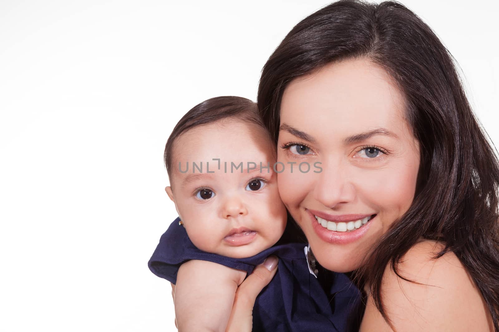 Mother and her baby girl looking at the camera