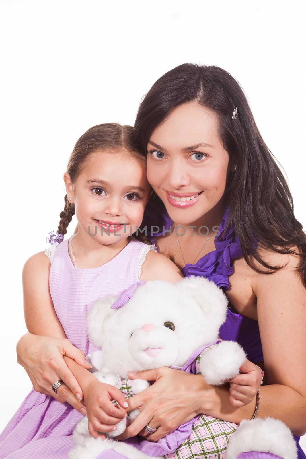 Mother with her young girl and a teddy bear