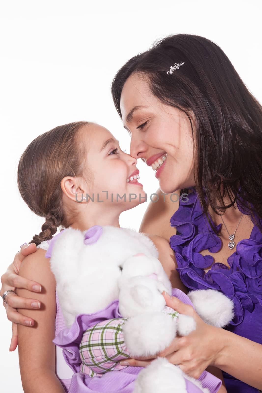 Mother with her young girl and a teddy bear