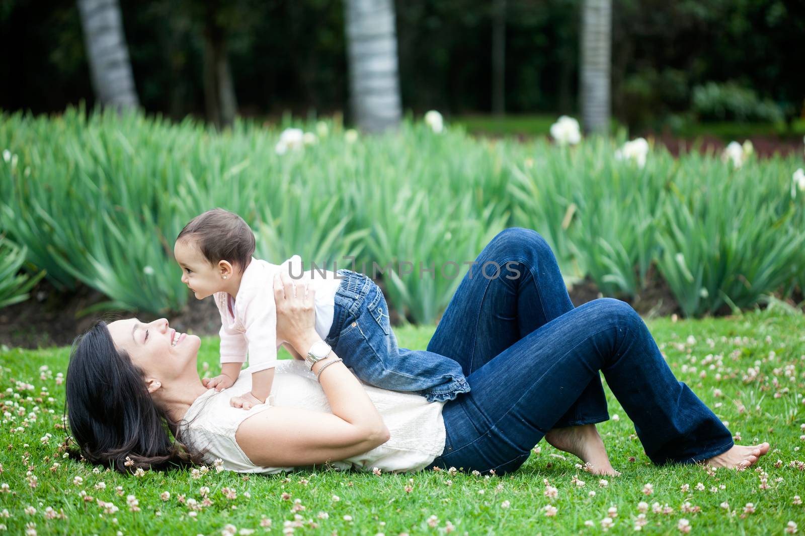 Baby girl playing with her mom on the grass by anamejia18