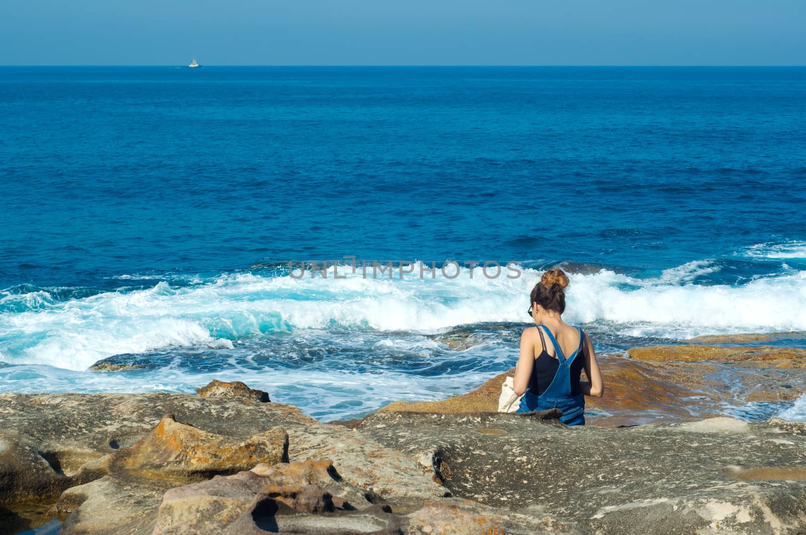 young woman against the blue sea