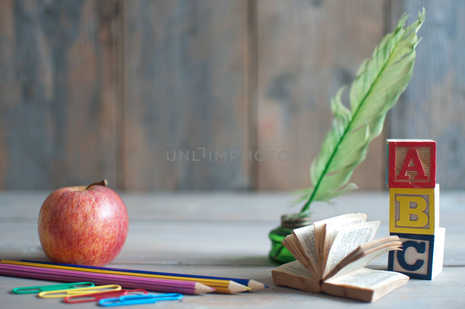 Stationery objects, miniature book and apple with background space 