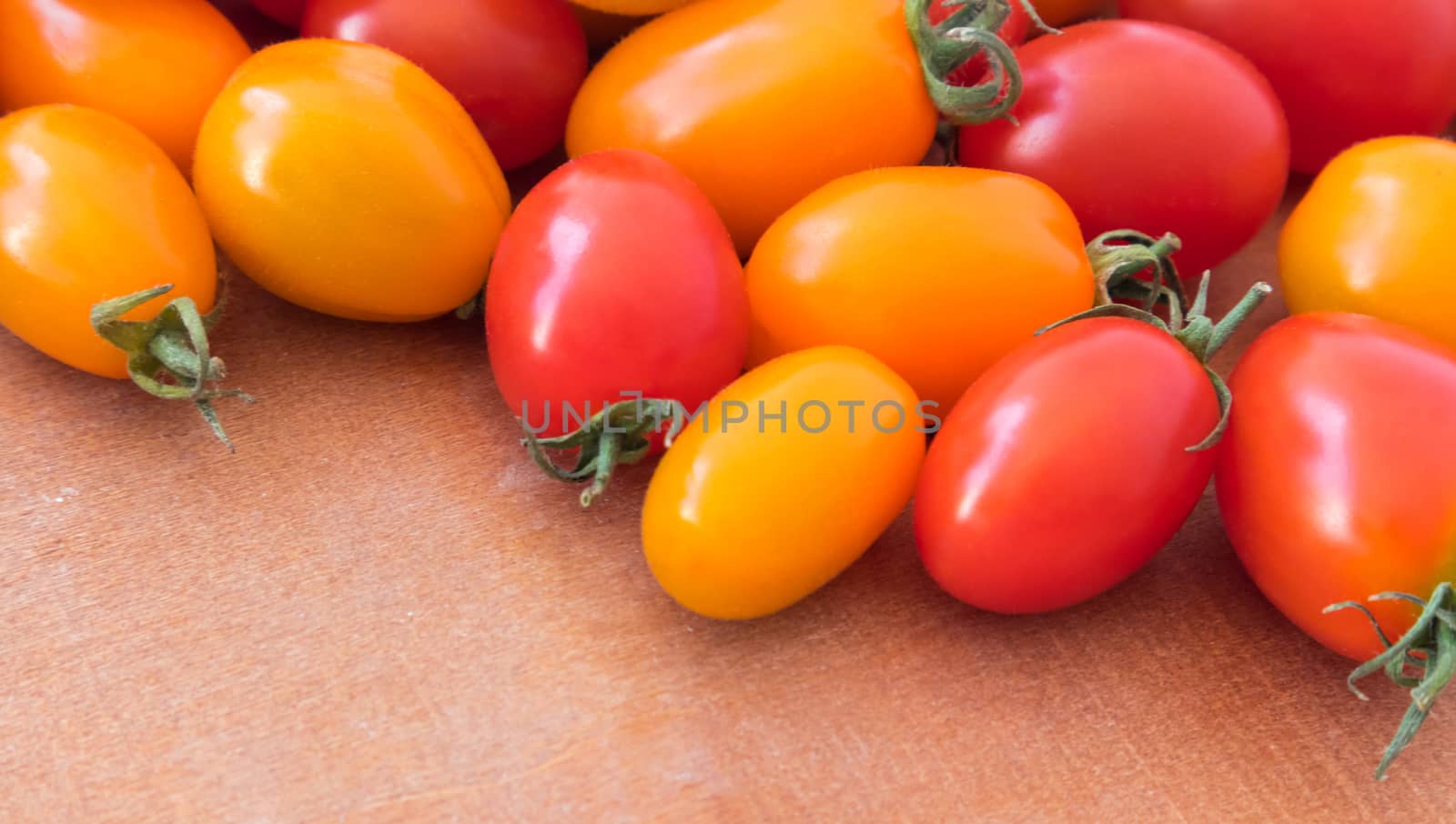 Closeup fresh cherry tomatoes on wood background