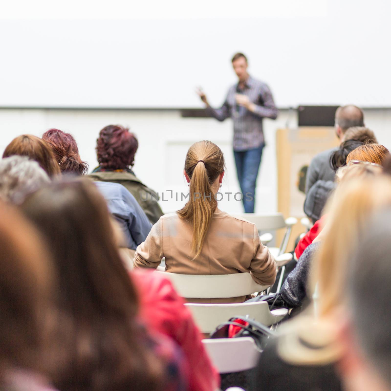 Public speaker giving talk at Business Event. by kasto