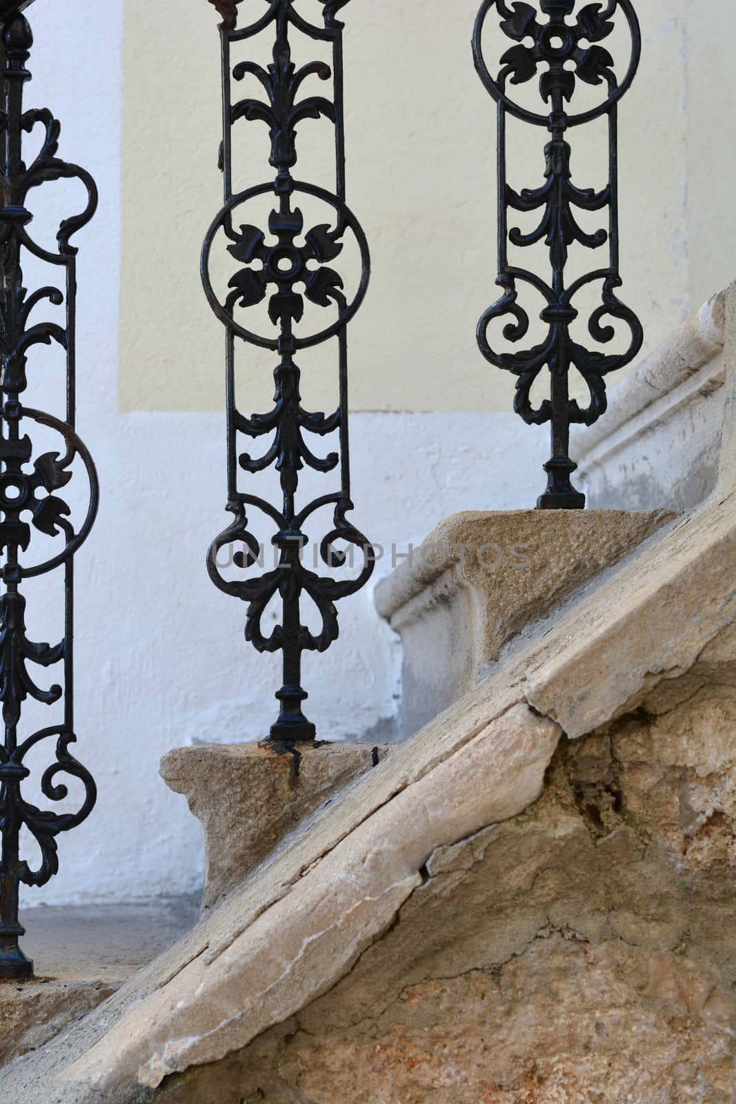 Detail of an old wrought iron fence on stone staircase 