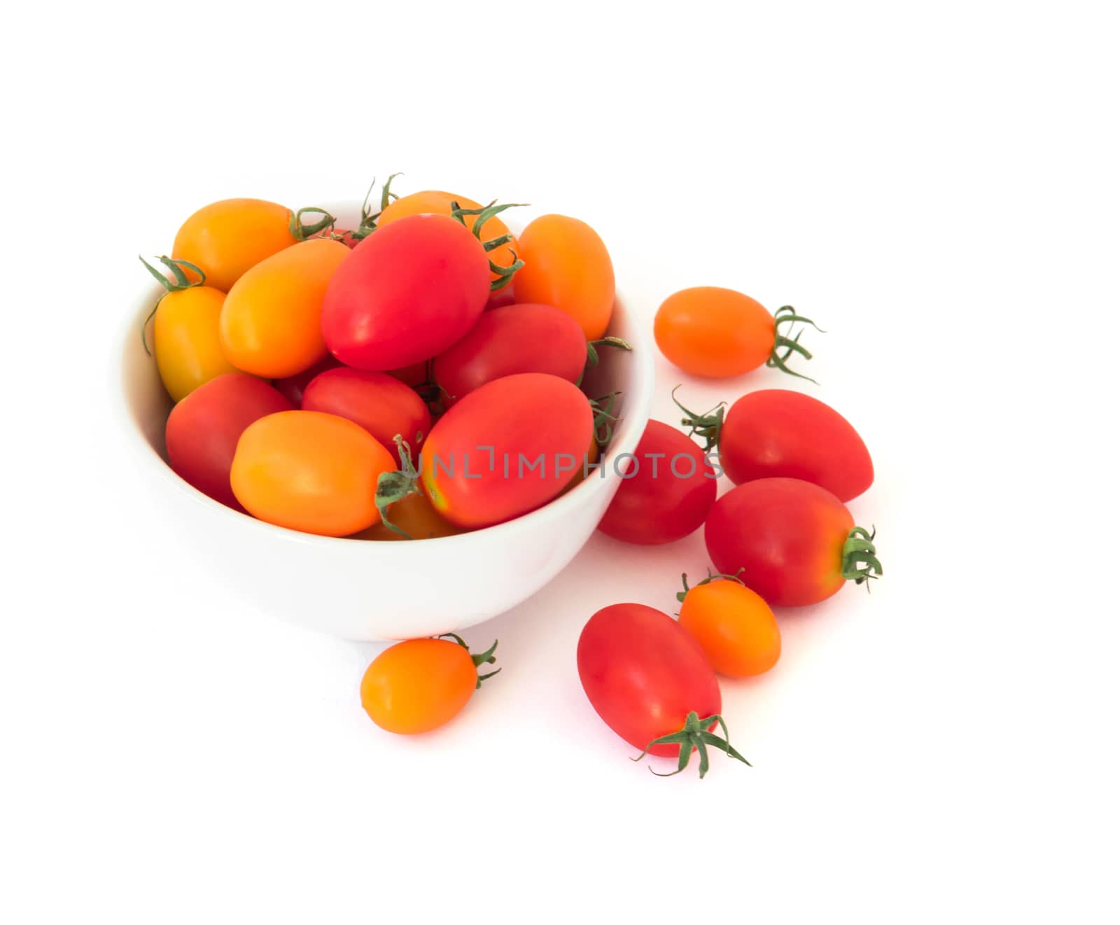 Fresh cherry tomatoes in bowl on white background