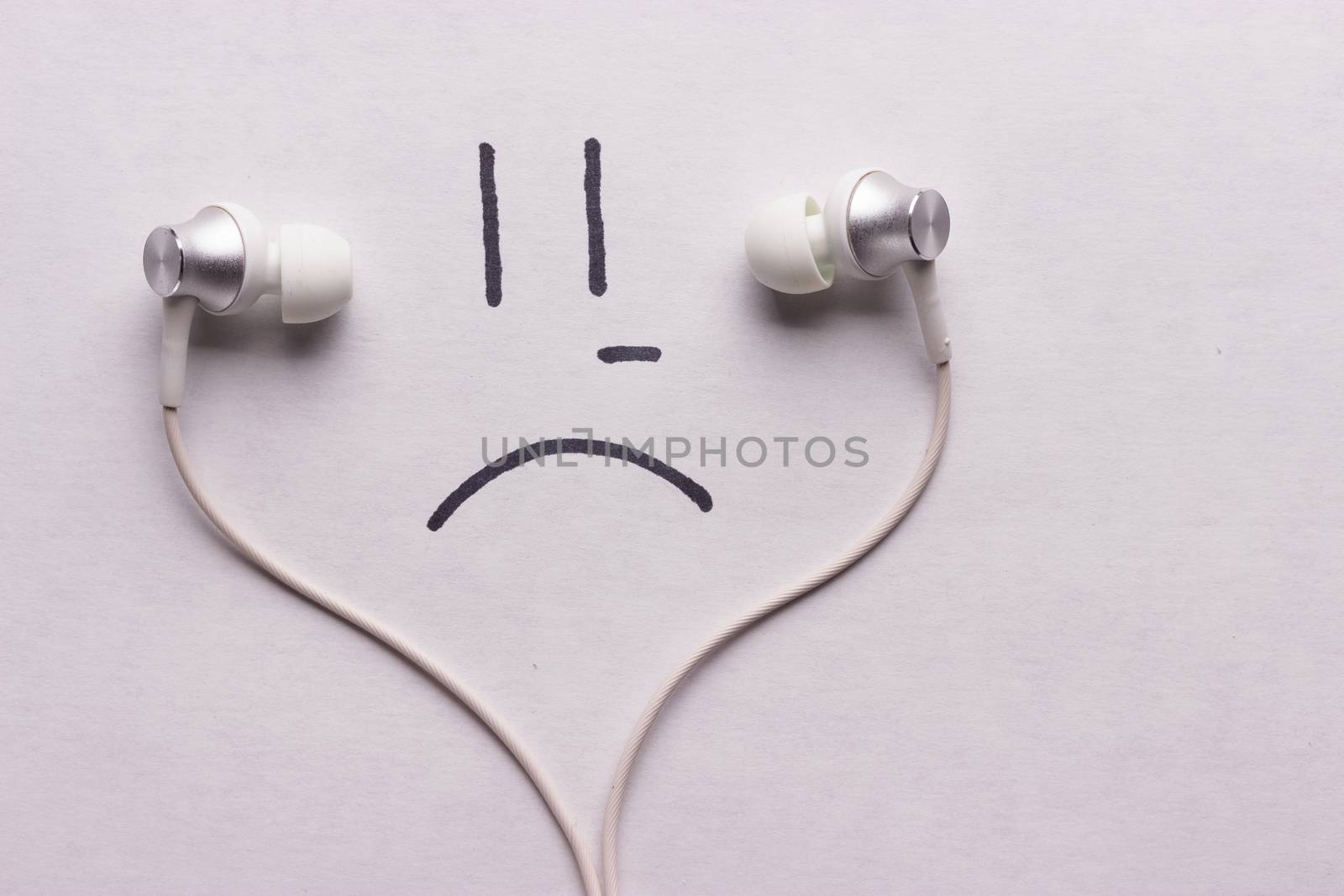 listen to sad music concept. headphones and sad smile
