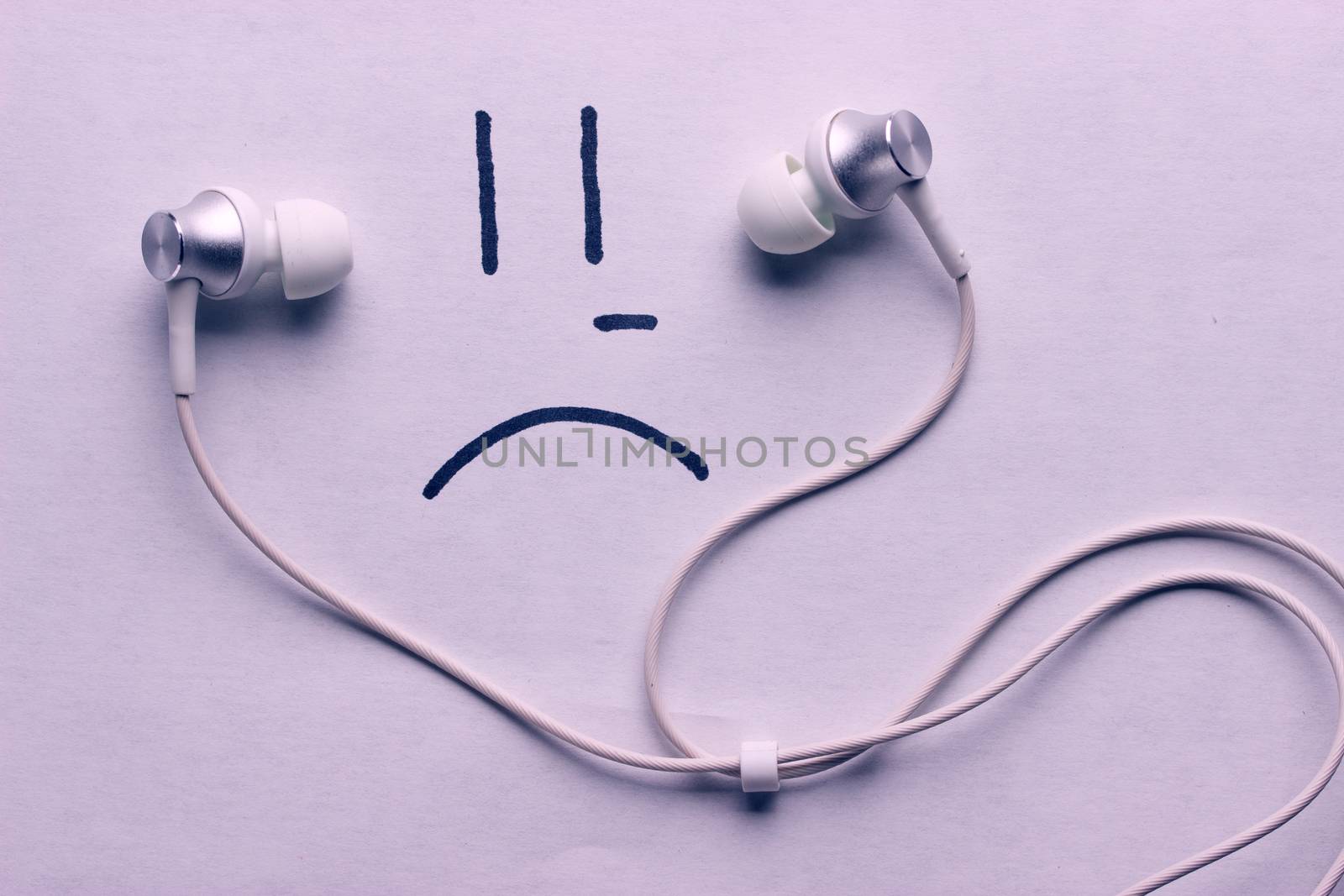 listen to sad music concept. headphones and sad smile