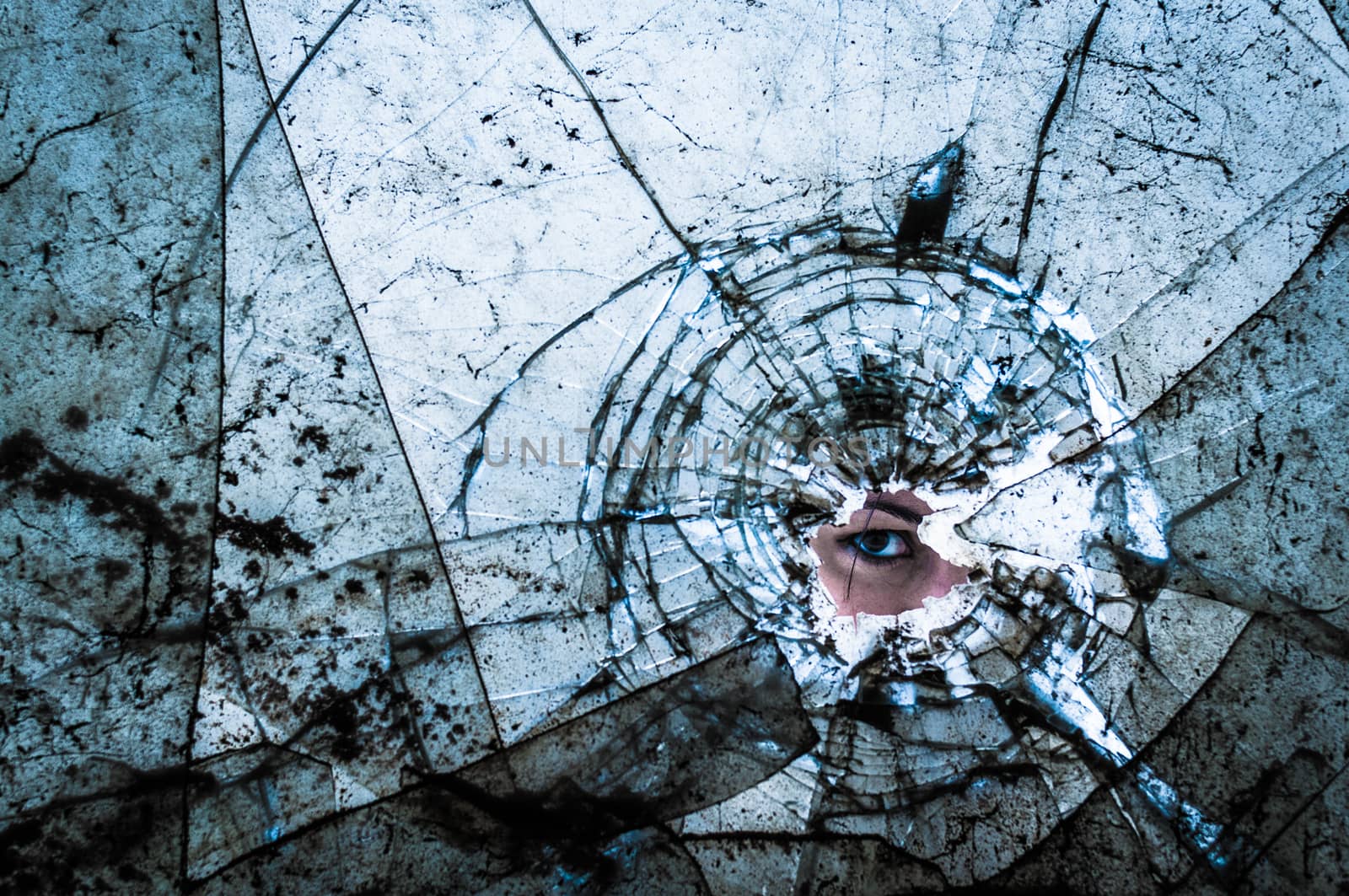 woman eye looking through break dirt window glass