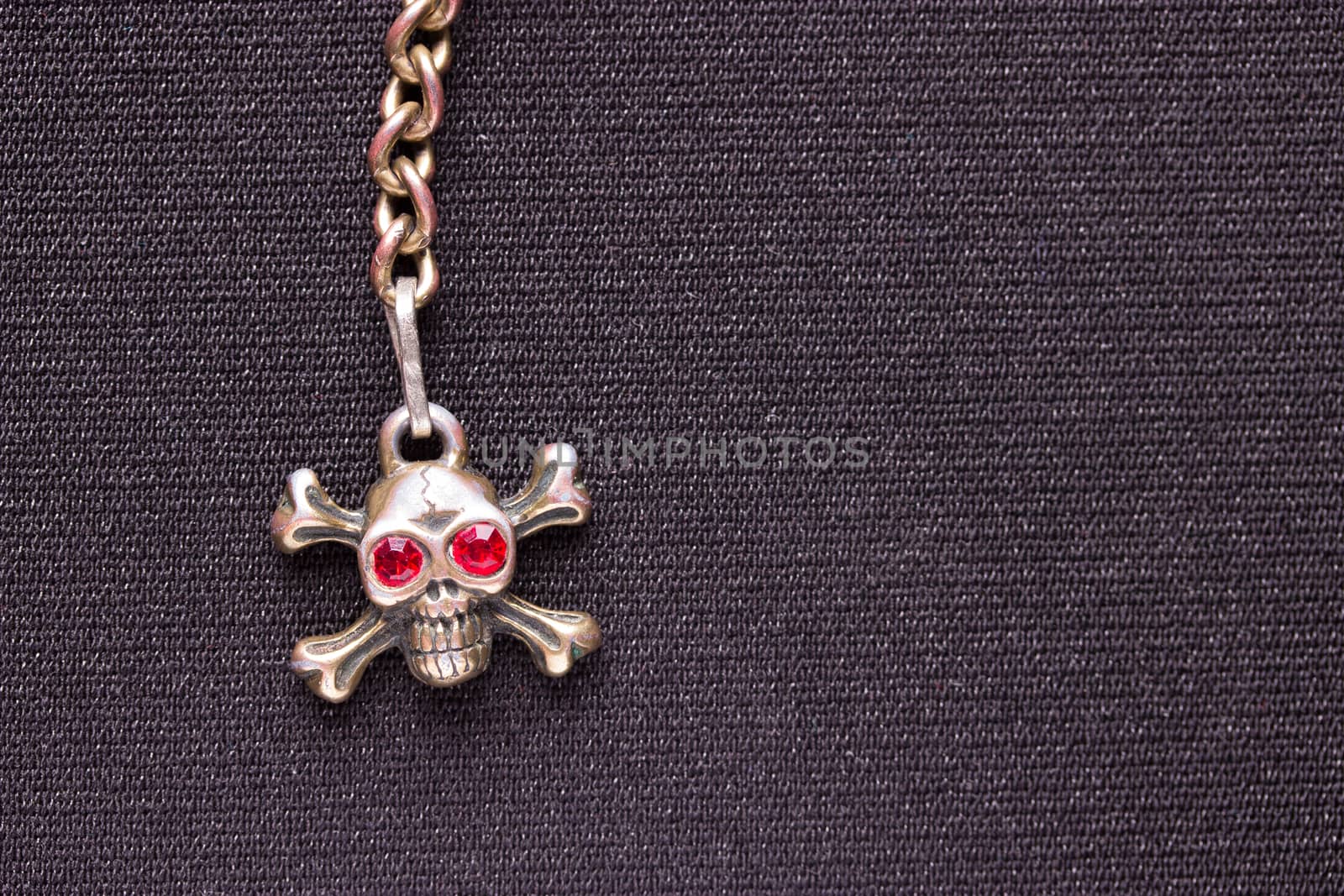 metal skull with red eyes. copy space