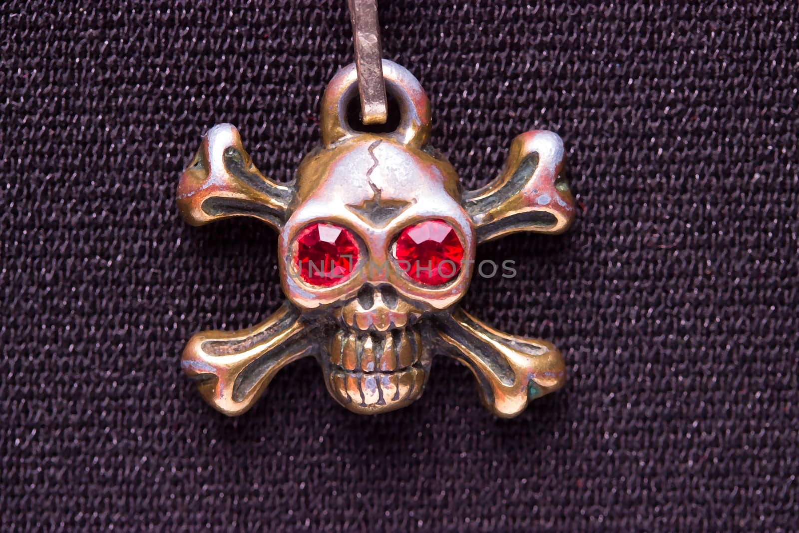 close up of metal skull with red eyes. pirate concept