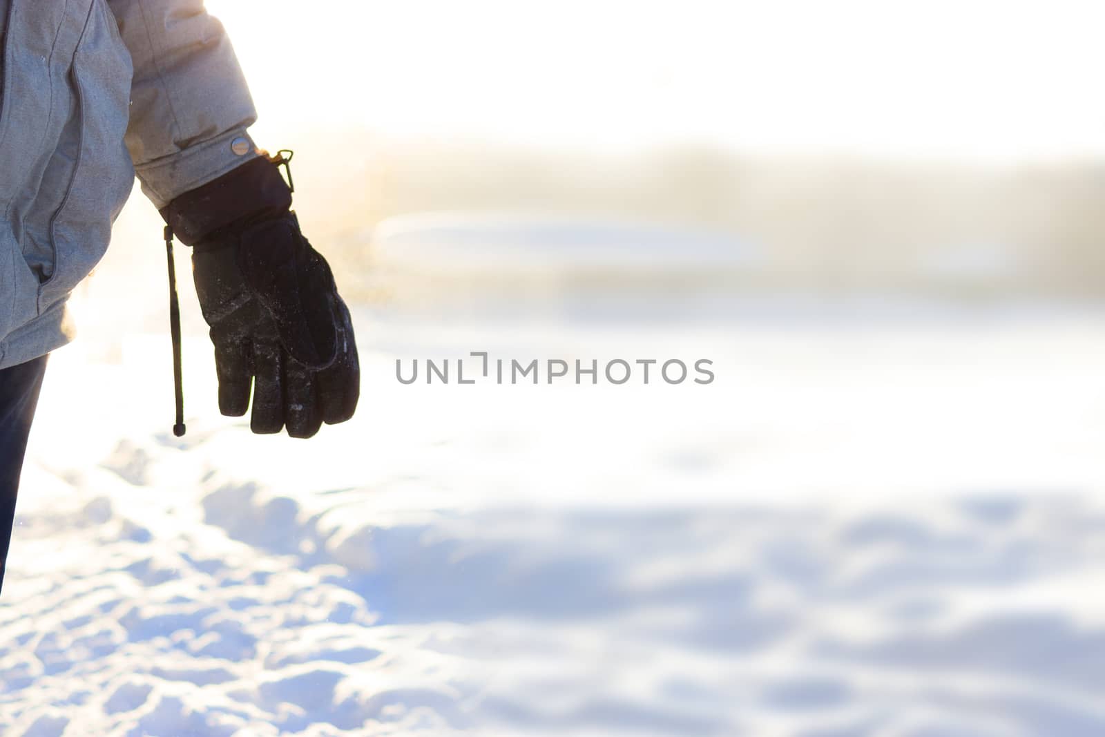 hand in warm gloves on background of snow. copy space