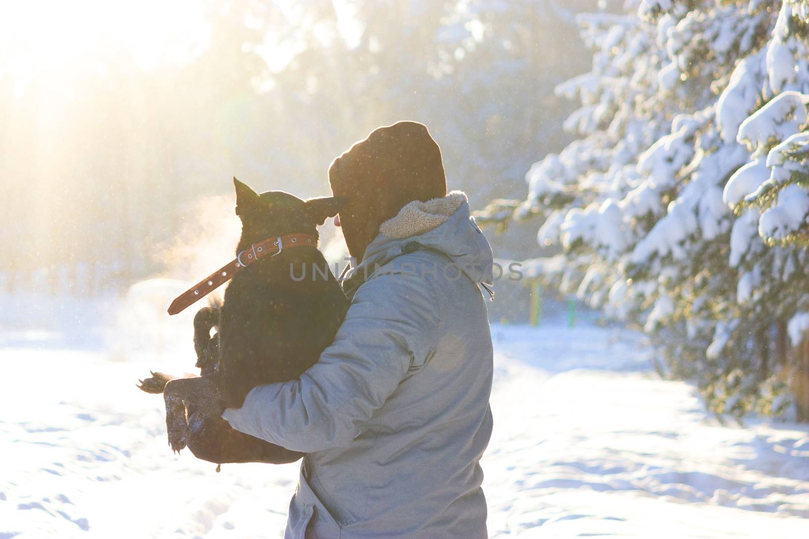 man take dog on his arm, because the dog is ill. winter