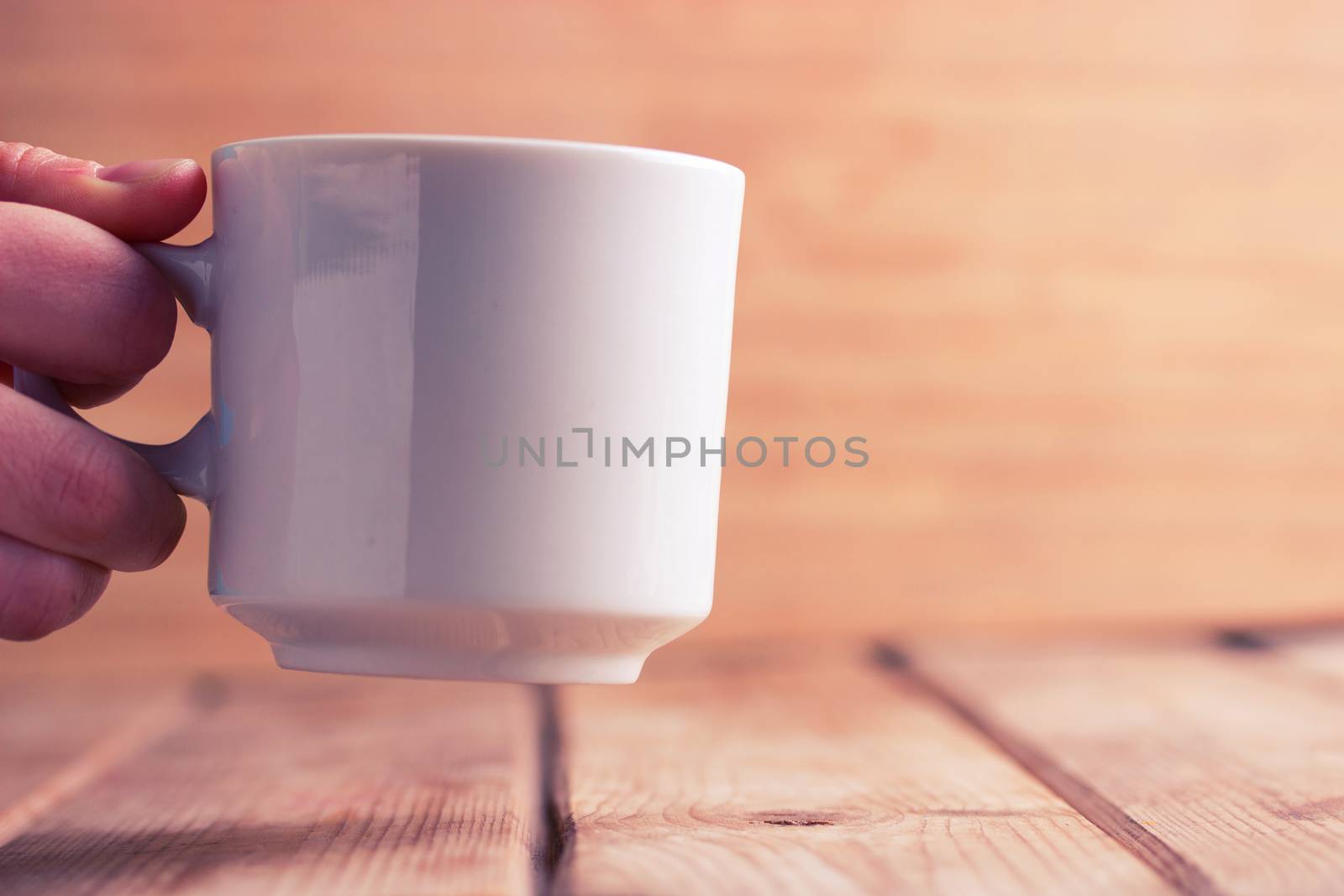 white Coffee cup in hand. mock up