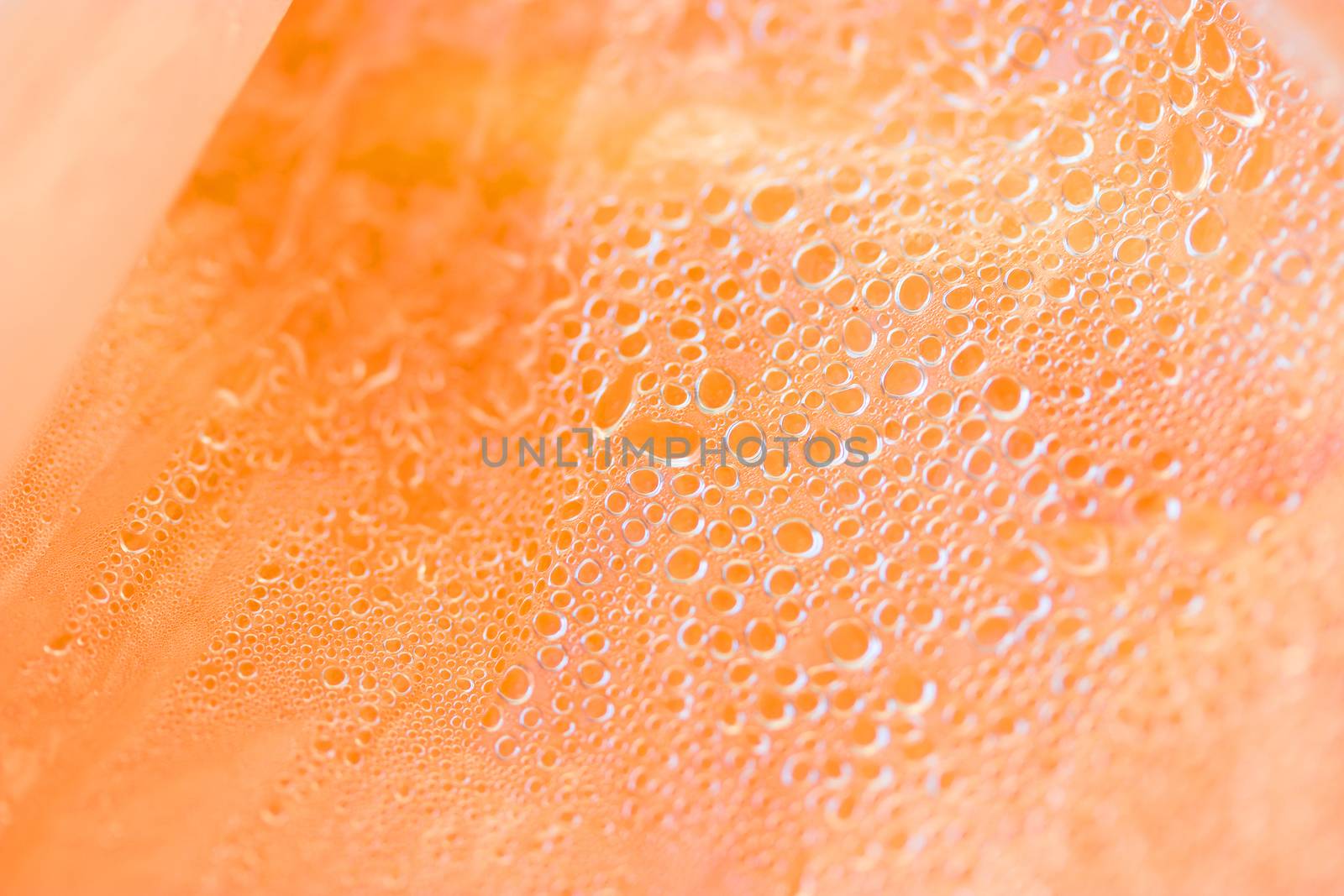 orange fruit in plastic package with water drops
