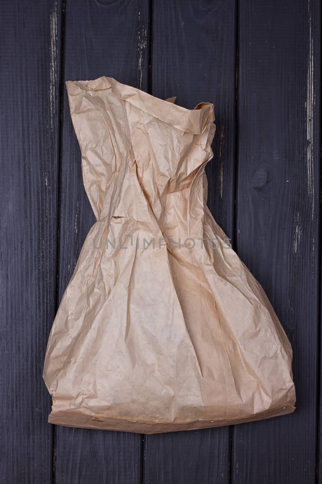 A bag of kraft paper on a black background