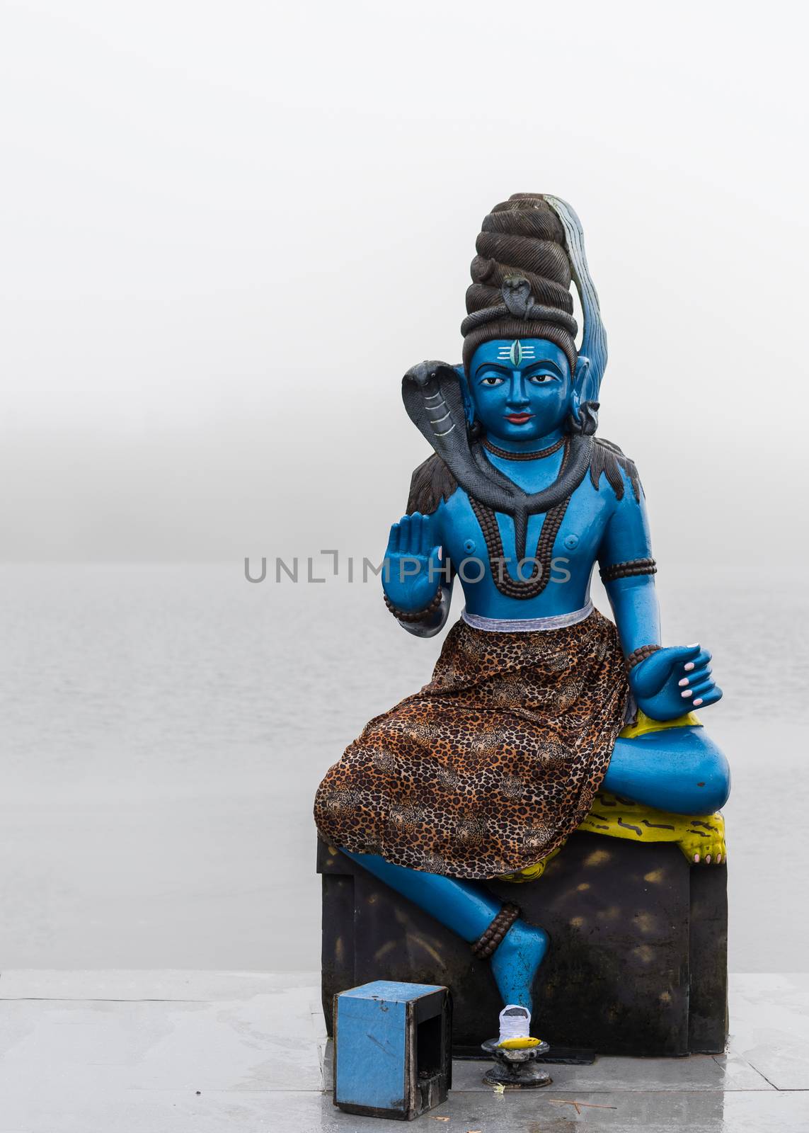 Statue of Shiva in a hindu temple (Grand Basin), in the day with fog ,mystical atmosphere.Mauritius