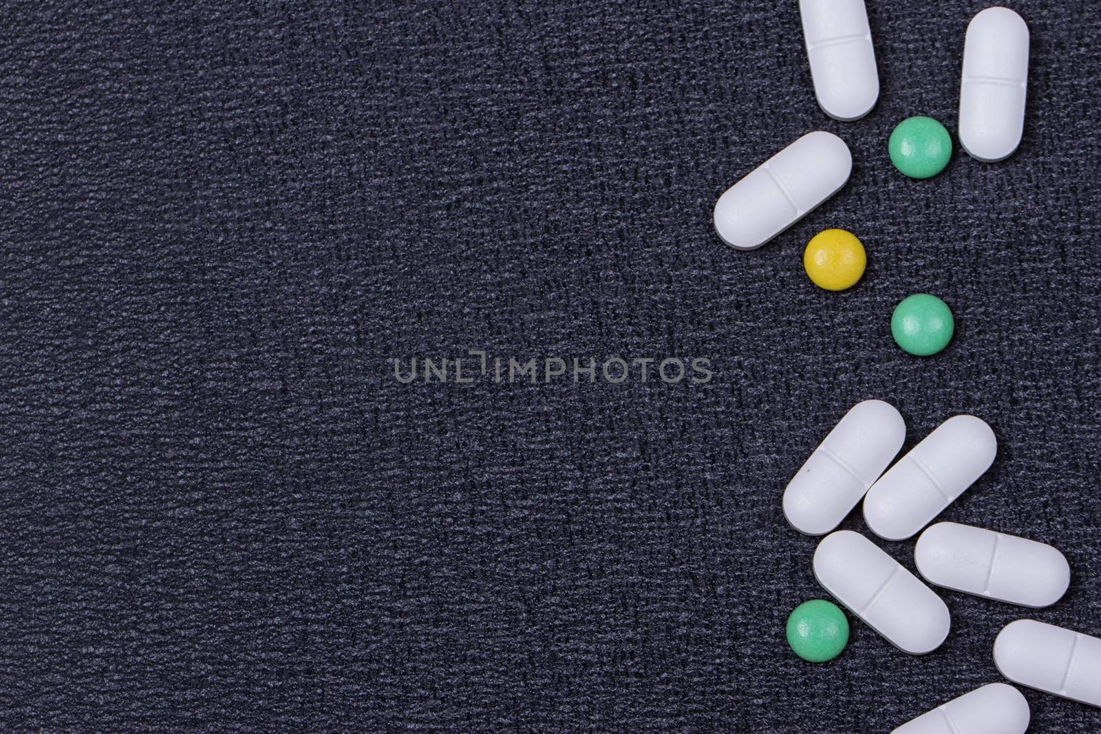 close up white pills on black background.