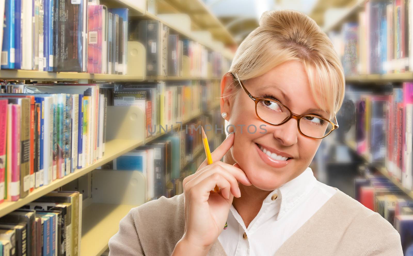 Beautiful Expressive Student or Teacher with Pencil in Library.