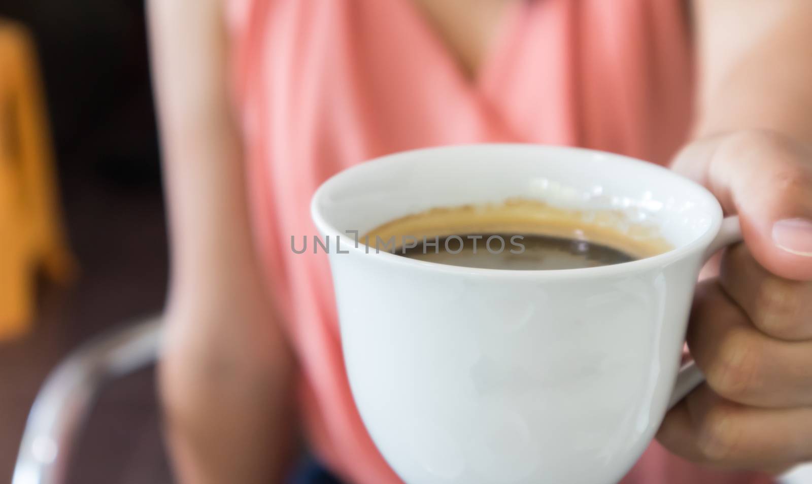 Closeup woman hand holding a cup of hot americano coffee, select by pt.pongsak@gmail.com