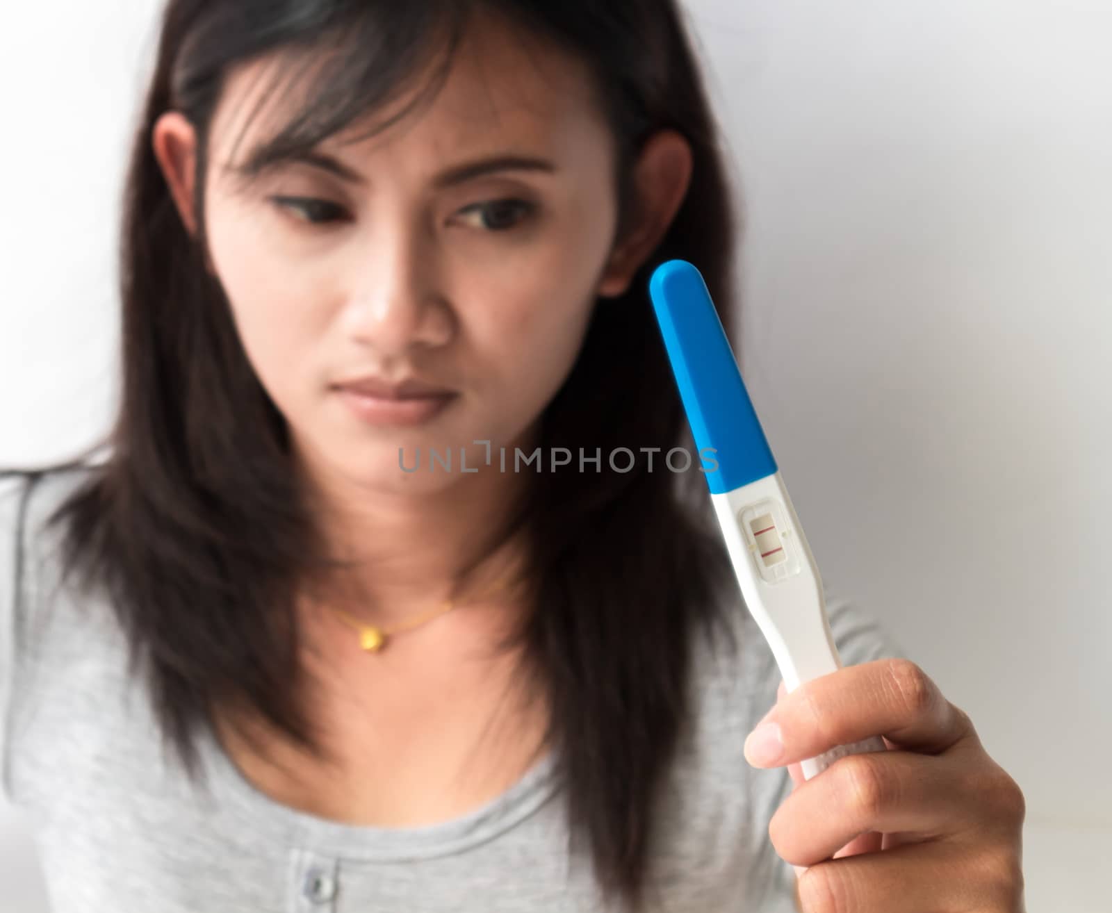 Woman hand holding pregnancy test