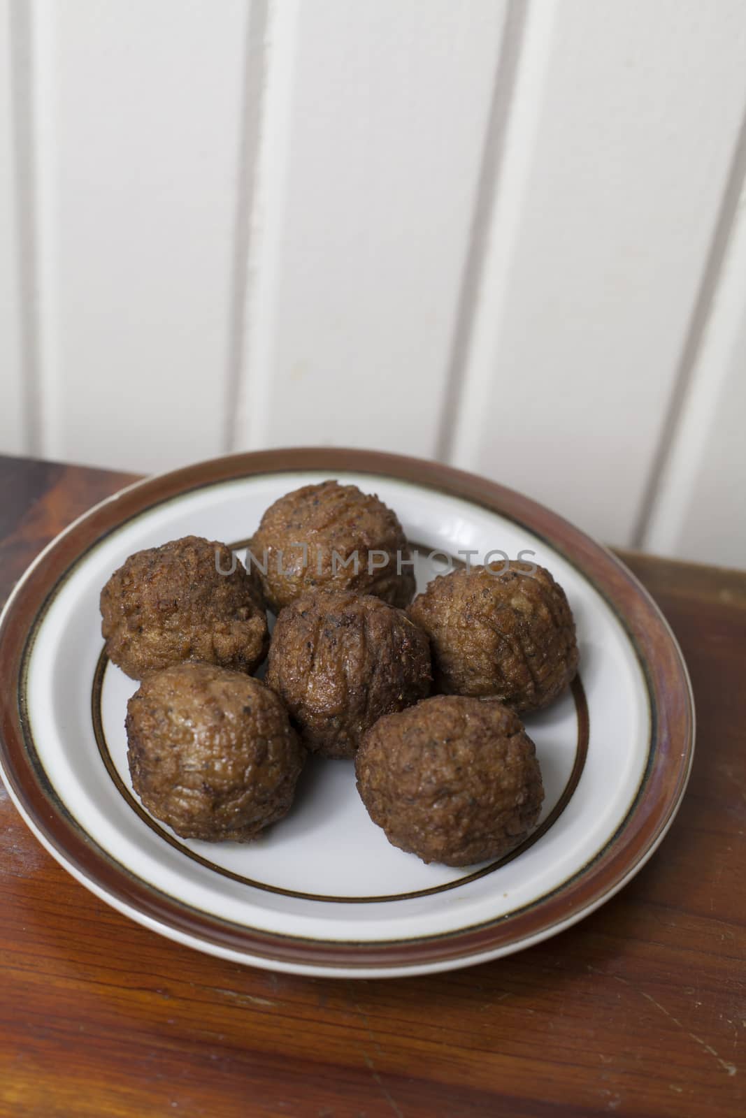 Five large soy-based meatballs on a small plate